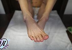 Oiled brunette teen teases tattooed feet and legs in closeup fetish display