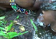 skinny ebony girl from tribe gets taken by stream in forest outdoors.
