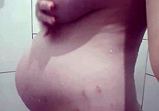 Pregnant blonde takes golden shower while bathing with friend