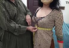 beautiful pakistani girl tries on outfits at busy tailor shop