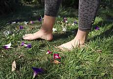Barefoot toes tease and crush flowers across the grassy ranch