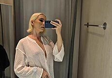 She slips into sheer transparent outfits in mall fitting room flashing big tits