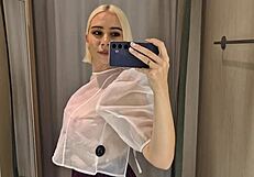 She slips into sheer transparent outfits in mall fitting room flashing big tits