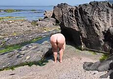 curvy spanish babe oils up for beach massage then fingers herself wildly