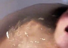 Woman enjoys extended bath session with self-touching and relaxation