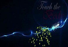 Two naked brunette babes slide boobs together on bed giving handjobs and blowjobs