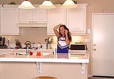 Cheerleader brunette babe fingers pussy and shakes tits for fans