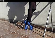 Discover her teasing curves in denim shorts black tights and tall heels