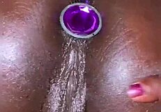 her anal plug slips in and pussy squirts effortlessly