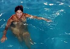 Hot Day Redhead Basks Nude in Pool