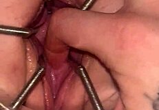 Fist queen's pussy stretches wide with metal ring.