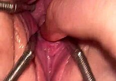 Fist queen's pussy stretches wide with metal ring.