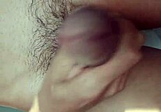 Guy strokes big cock publicly by bedroom window