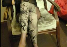 Crossdresser maria struts in black nylon pantyhose, panties, and towering high heels