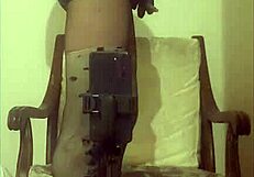 Crossdresser maria struts in black nylon pantyhose, panties, and towering high heels