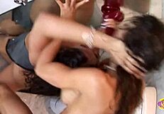 Two lesbians in heels fist and finger each other's buttholes on toilet