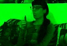 Beth's Kinky Goth Domina Smokes Seductively in Green