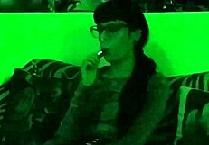 Beth's Kinky Goth Domina Smokes Seductively in Green