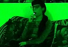 Beth's Kinky Goth Domina Smokes Seductively in Green