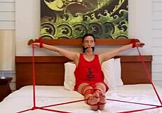 Sofi lies bound on bed with tight red ropes restraining her completely part 2