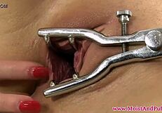 Seductive tattooed babe in heels rips clothes to spread pussy wide with speculum closeup