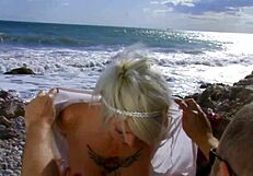 Tattooed blonde mom rides monster cock on beach