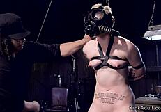 blonde slave bound in gas mask endures choking whips and rough gagging torment
