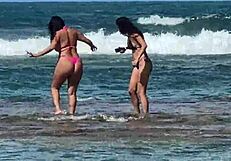 two pretty brazilian brunettes kiss and play on coral beach first time public
