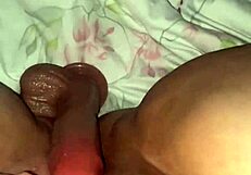 dark bodysuit grinds huge clit dildo toy over shaved pussy closeup