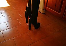 mistress in tall heels and boots dominates huge slave in garage bdsm session with ass worship