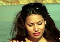 Zola's fun beach striptease reveals shaved small tits outdoors
