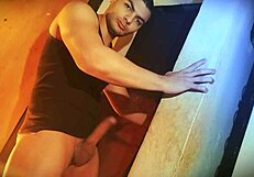 Muscular bodybuilder's MONSTER COCK struggles hard against wall sexy lift challenge