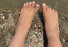 check out this curvy Asian brunette's huge natural tits and soft soles teasing on the beach