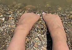 check out this curvy Asian brunette's huge natural tits and soft soles teasing on the beach