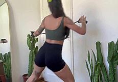 Inked babe stretches with rubber bands in sfw yoga fitness warm-up