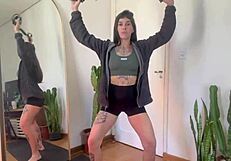 Inked babe stretches with rubber bands in sfw yoga fitness warm-up