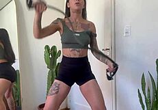 Inked babe stretches with rubber bands in sfw yoga fitness warm-up