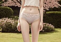 Lingerie models pose barefoot in panties under cherry blossom trees
