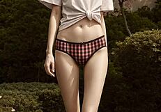 Lingerie models pose barefoot in panties under cherry blossom trees