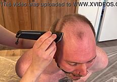 Goddess shaves sub's head while dominating in femdom piss salon ritual