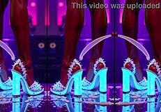 High Heels Dangling Off Counter Legs Spread in Pulsing Nightclub Glow