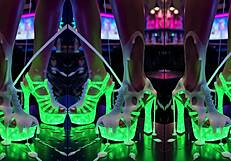 High Heels Dangling Off Counter Legs Spread in Pulsing Nightclub Glow