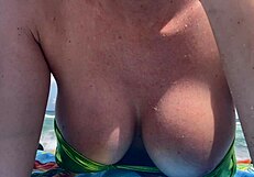 Hey Italian milf Artemisia teases huge tits in micro bikini at Miami beach