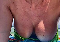 Hey Italian milf Artemisia teases huge tits in micro bikini at Miami beach