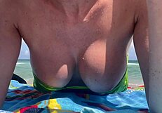 Hey Italian milf Artemisia teases huge tits in micro bikini at Miami beach