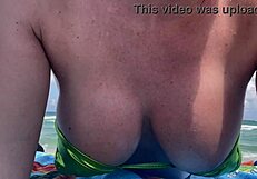 Hey Italian milf Artemisia teases huge tits in micro bikini at Miami beach