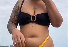 young african usa girl in tight yellow bikini splits swollen pussy on beach