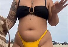 young african usa girl in tight yellow bikini splits swollen pussy on beach
