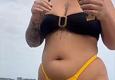young african usa girl in tight yellow bikini splits swollen pussy on beach