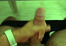 muscular athlete massages throbbing cock gently on bed
